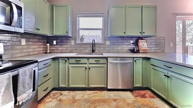 a kitchen with a sink cabinets and stainless steel appliances