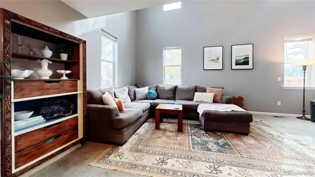 a living room with furniture and a rug