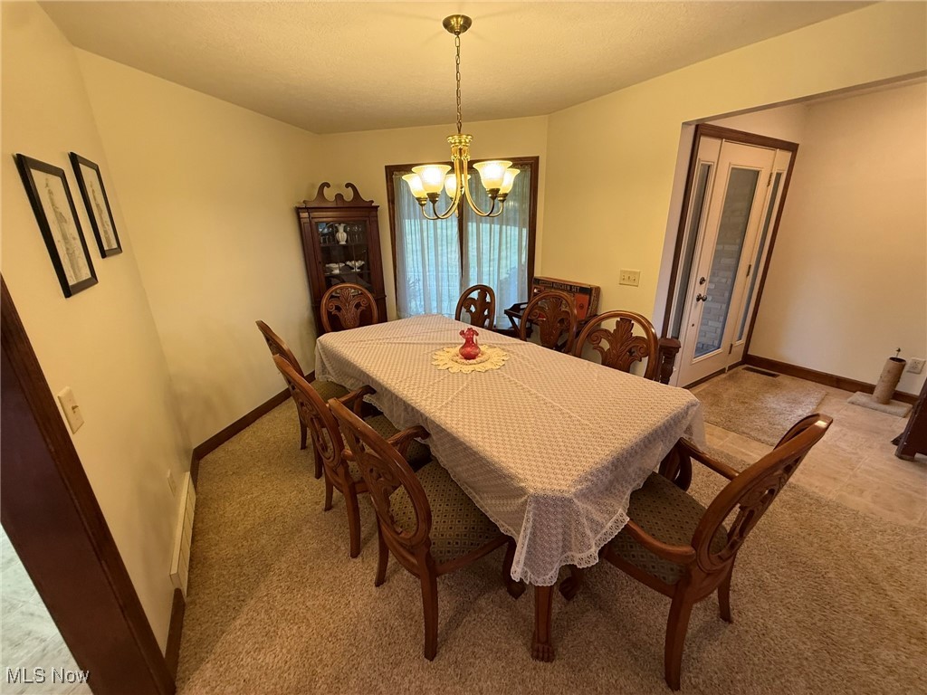 2597 Pyle Road Dover, OH 44622 - Photo 19 of 50 Dining space with light carpet and a chandelier