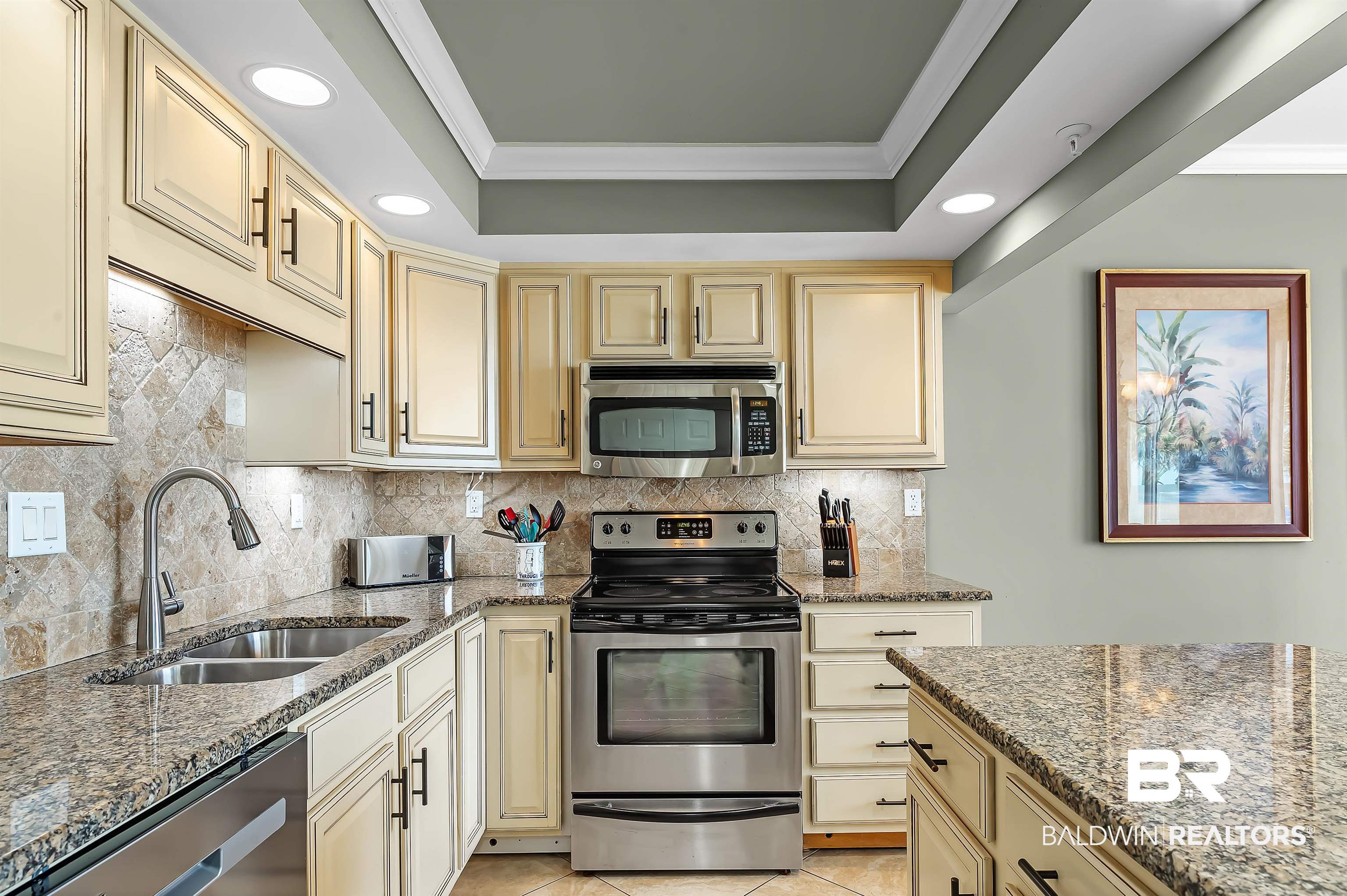 16287 Perdido Key Drive, Unit 105 Pensacola, FL 32507 - Photo 23 of 66 Kitchen featuring light-toned cabinetry with dark hardware, stone countertops, and a full stainless steel appliance package