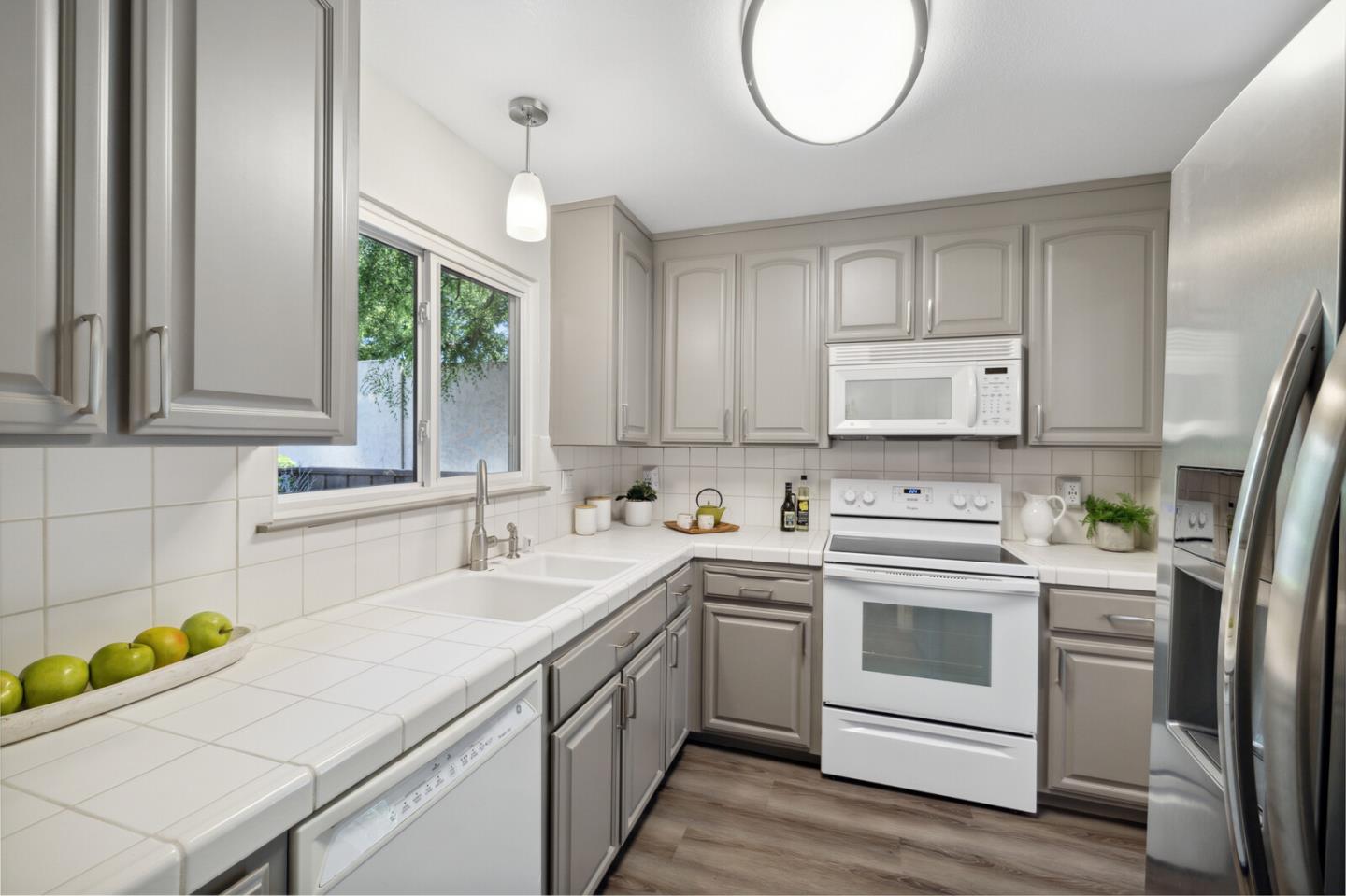 118 Granada Drive Mountain View, CA 94043 - Photo 3 of 28 a kitchen that has a sink and a stove top oven