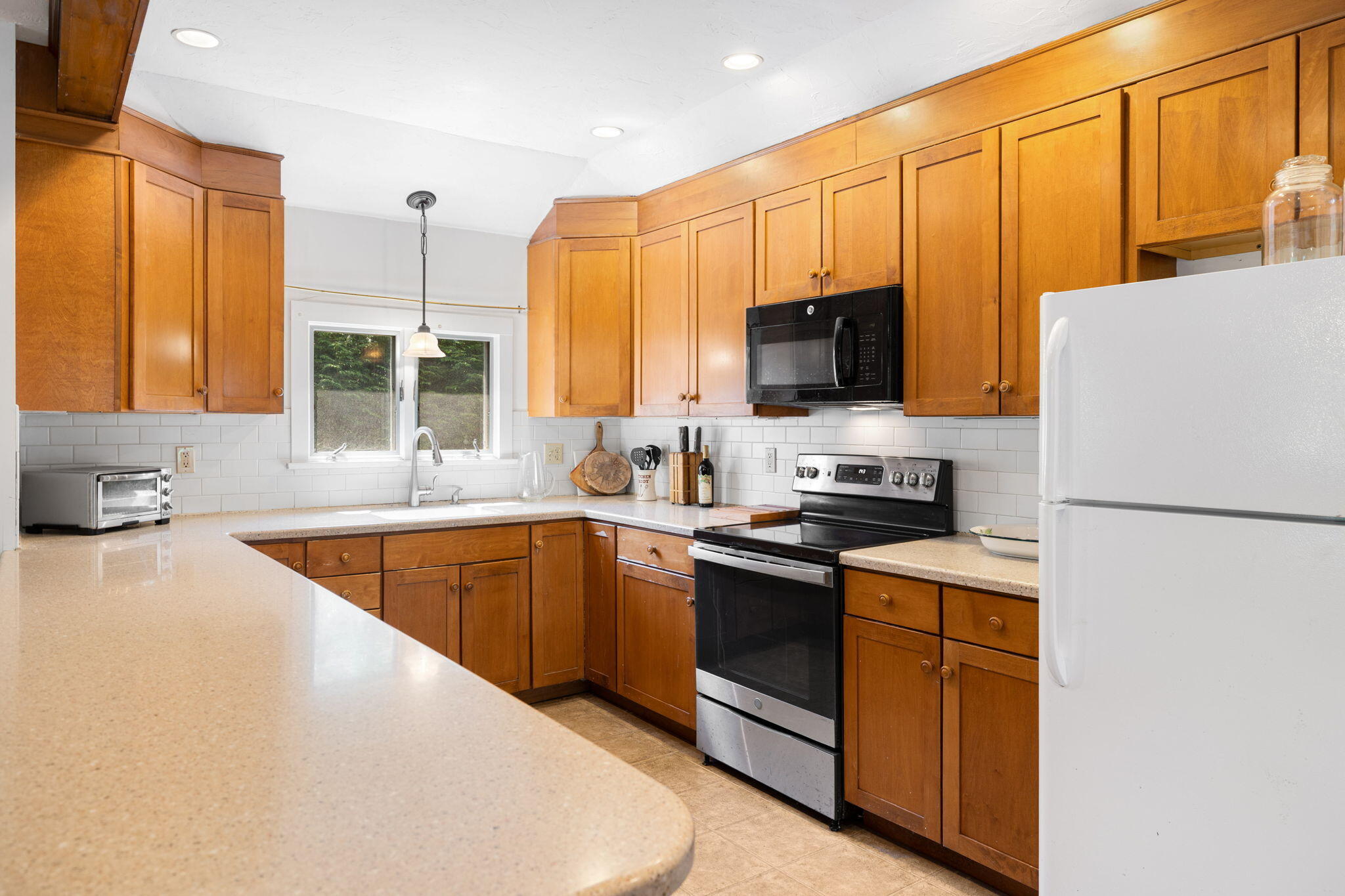 89 Swift Avenue Osterville, MA 02655 - Photo 22 of 57 a kitchen with stainless steel appliances granite countertop a stove a sink dishwasher a refrigerator and a microwave