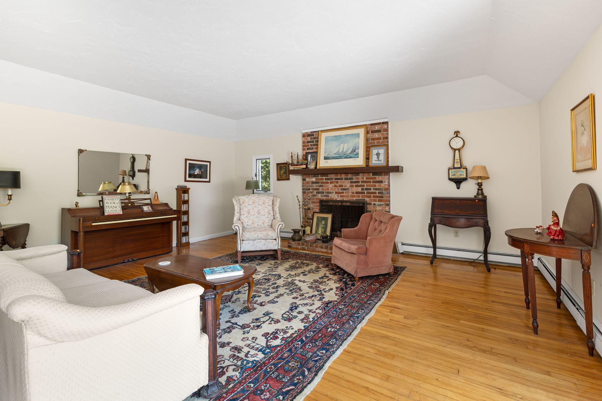 89 Swift Avenue Osterville, MA 02655 - Photo 36 of 57 a living room with furniture and a fireplace