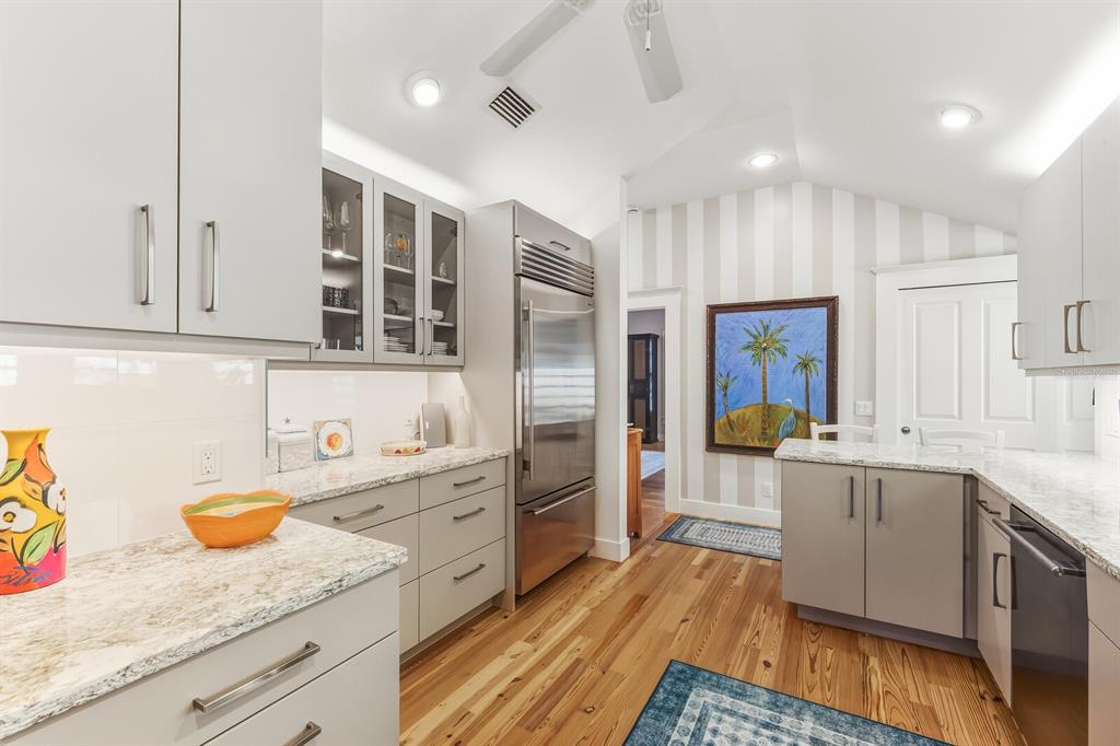 361 Tarpon Avenue Boca Grande, FL 33921 - Photo 11 of 25 a kitchen with stainless steel appliances granite countertop refrigerator sink and cabinets