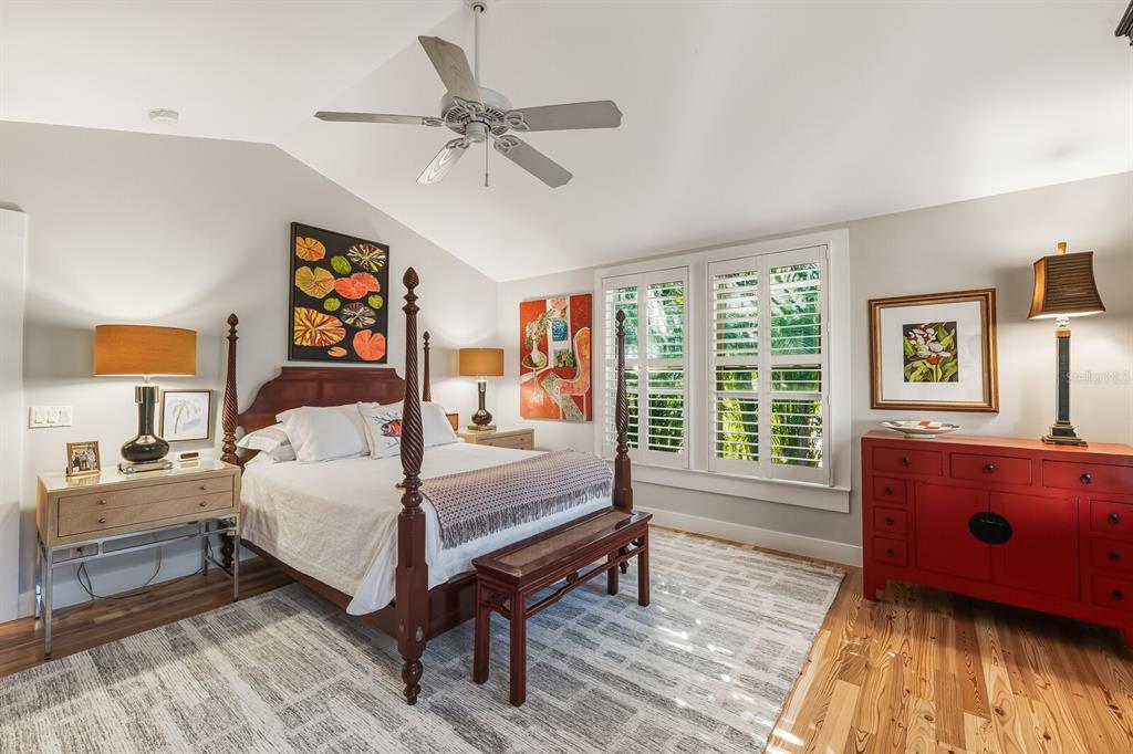 361 Tarpon Avenue Boca Grande, FL 33921 - Photo 13 of 25 a bedroom with a bed and wooden floor