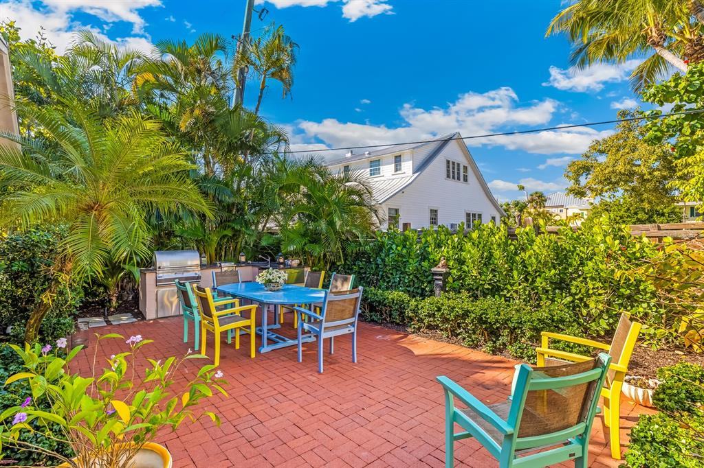 361 Tarpon Avenue Boca Grande, FL 33921 - Photo 21 of 25 a backyard of a house with table and chairs