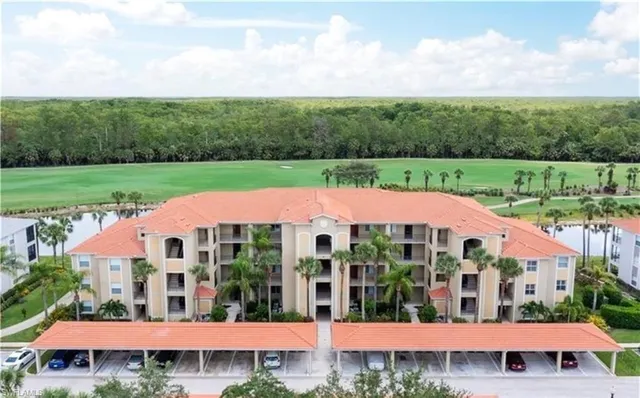 a view of a white house with a yard