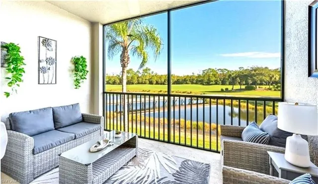a balcony with couches and a potted plant