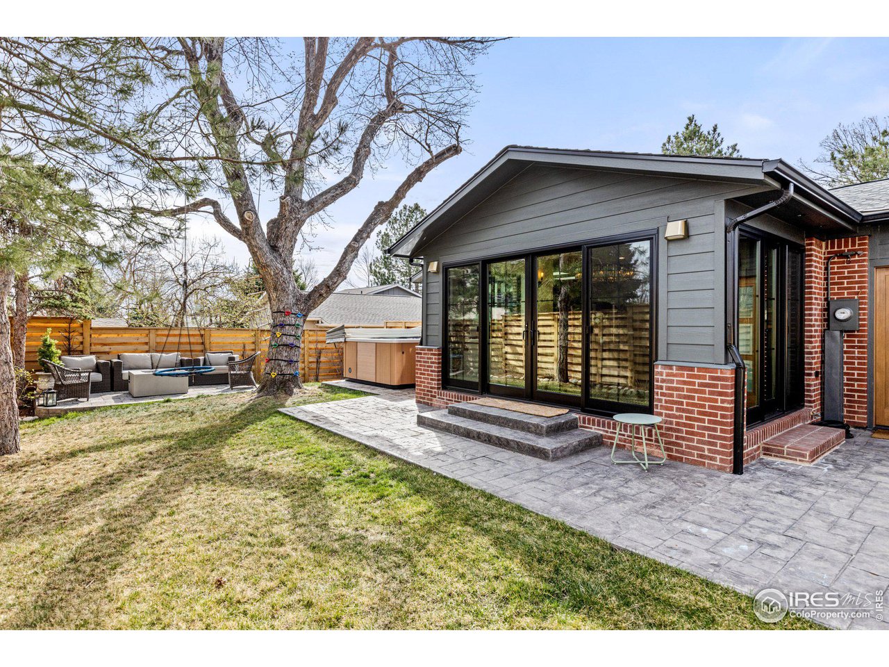 2685 Stephens Road Boulder, CO 80305 - Photo 32 of 40 a view of a house with a large tree and wooden fence