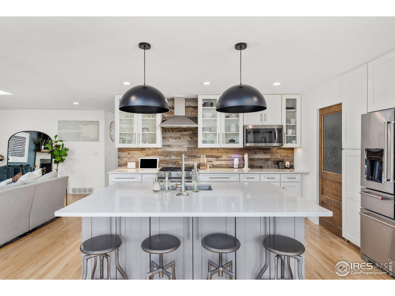 2685 Stephens Road Boulder, CO 80305 - Photo 9 of 40 a kitchen with stainless steel appliances a table chairs and white cabinets