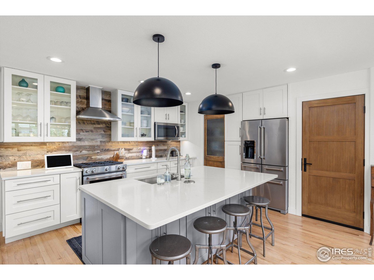 2685 Stephens Road Boulder, CO 80305 - Photo 10 of 40 a kitchen with stainless steel appliances a sink a stove a refrigerator and cabinets
