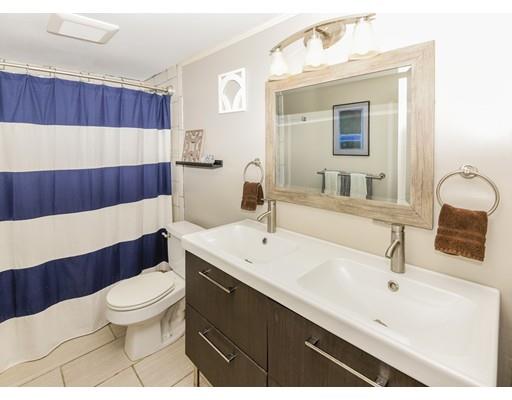 360 Sprague Street Dedham, MA 02026 - Photo 10 of 19 a bathroom with a sink a toilet and a mirror
