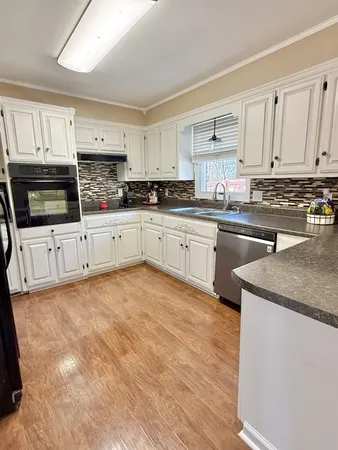 a kitchen with stainless steel appliances granite countertop a stove sink and cabinets