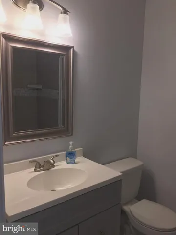 a bathroom with a sink toilet and mirror