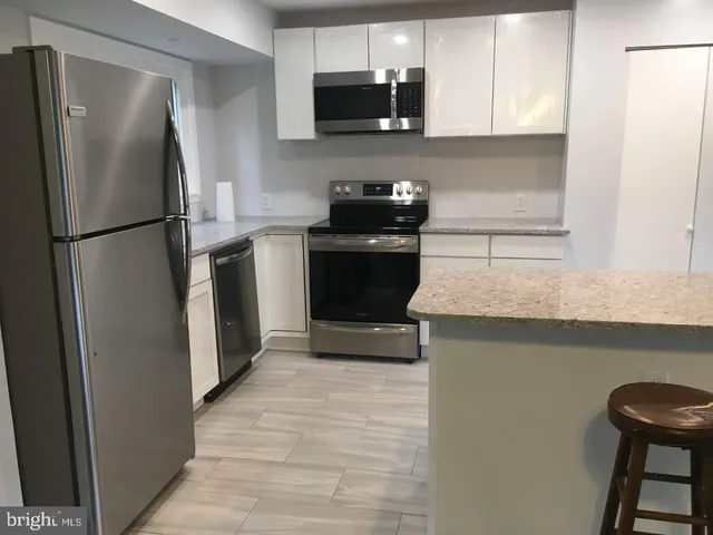 a kitchen with a refrigerator and a sink