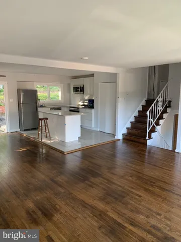 a view of kitchen with furniture and wooden floor