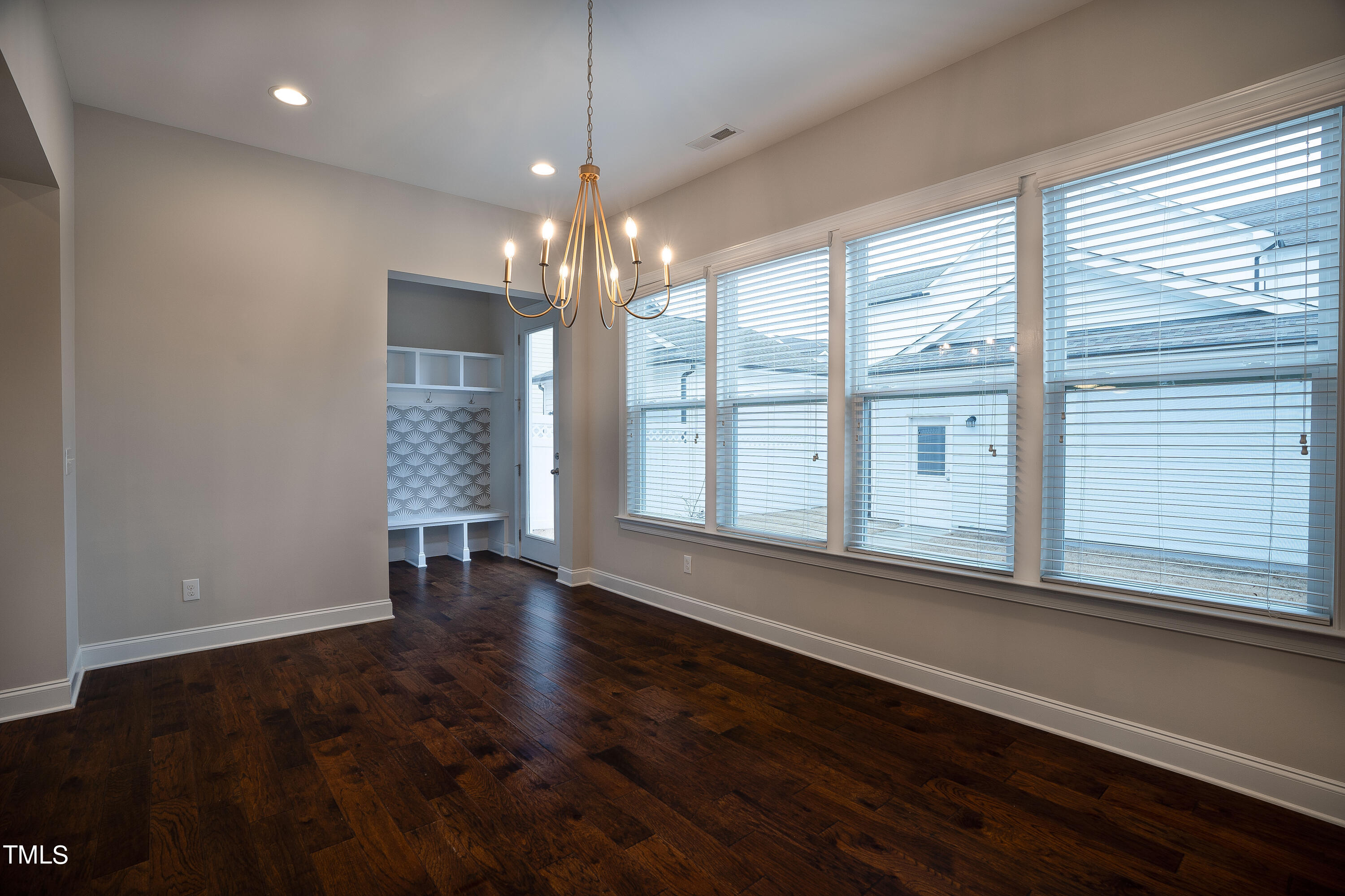665 Old Dairy Drive Wake Forest, NC 27587 - Photo 11 of 30 a view of an empty room with wooden floor and a window