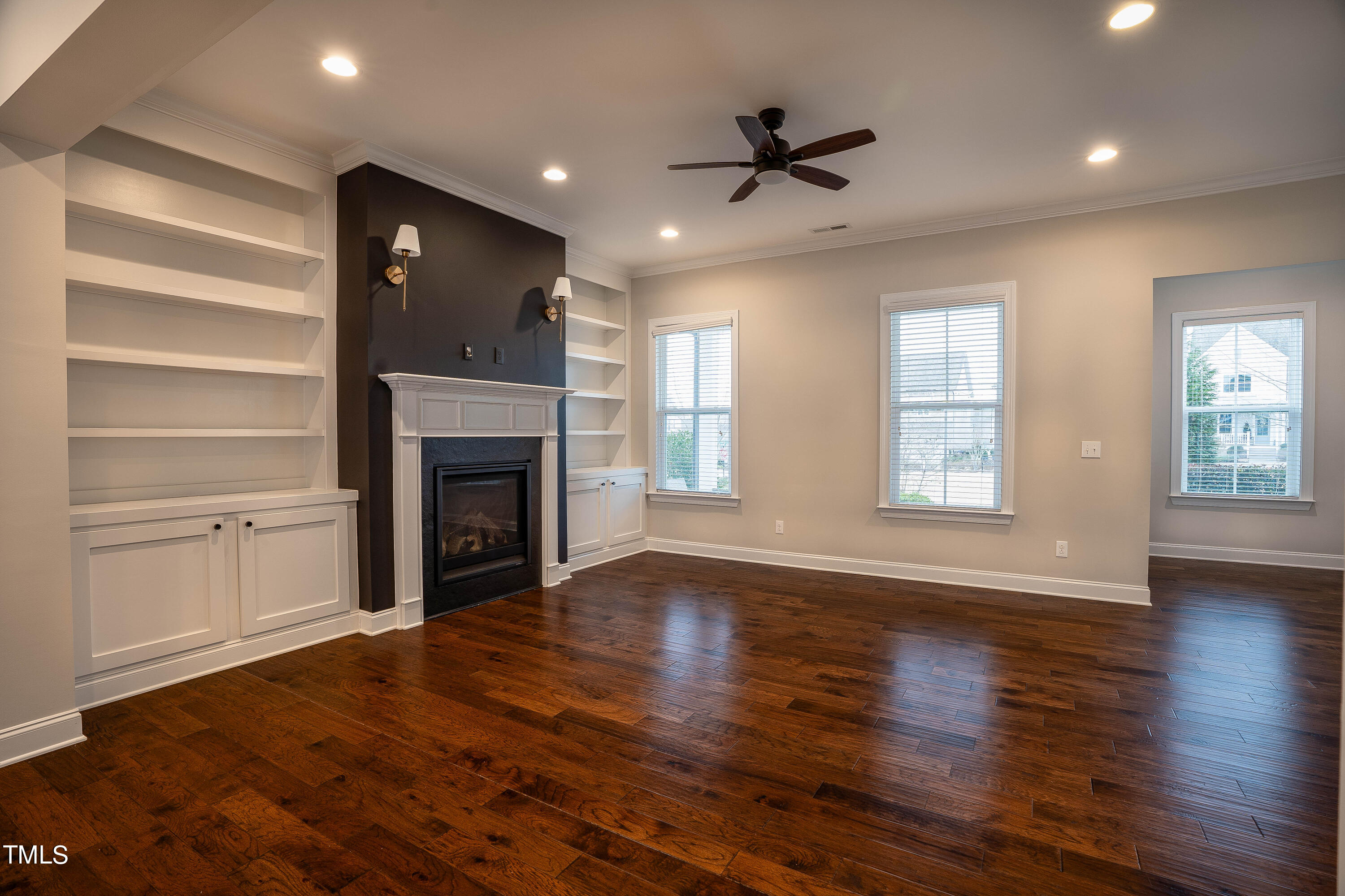 665 Old Dairy Drive Wake Forest, NC 27587 - Photo 5 of 30 a view of an empty room with wooden floor fireplace and a window