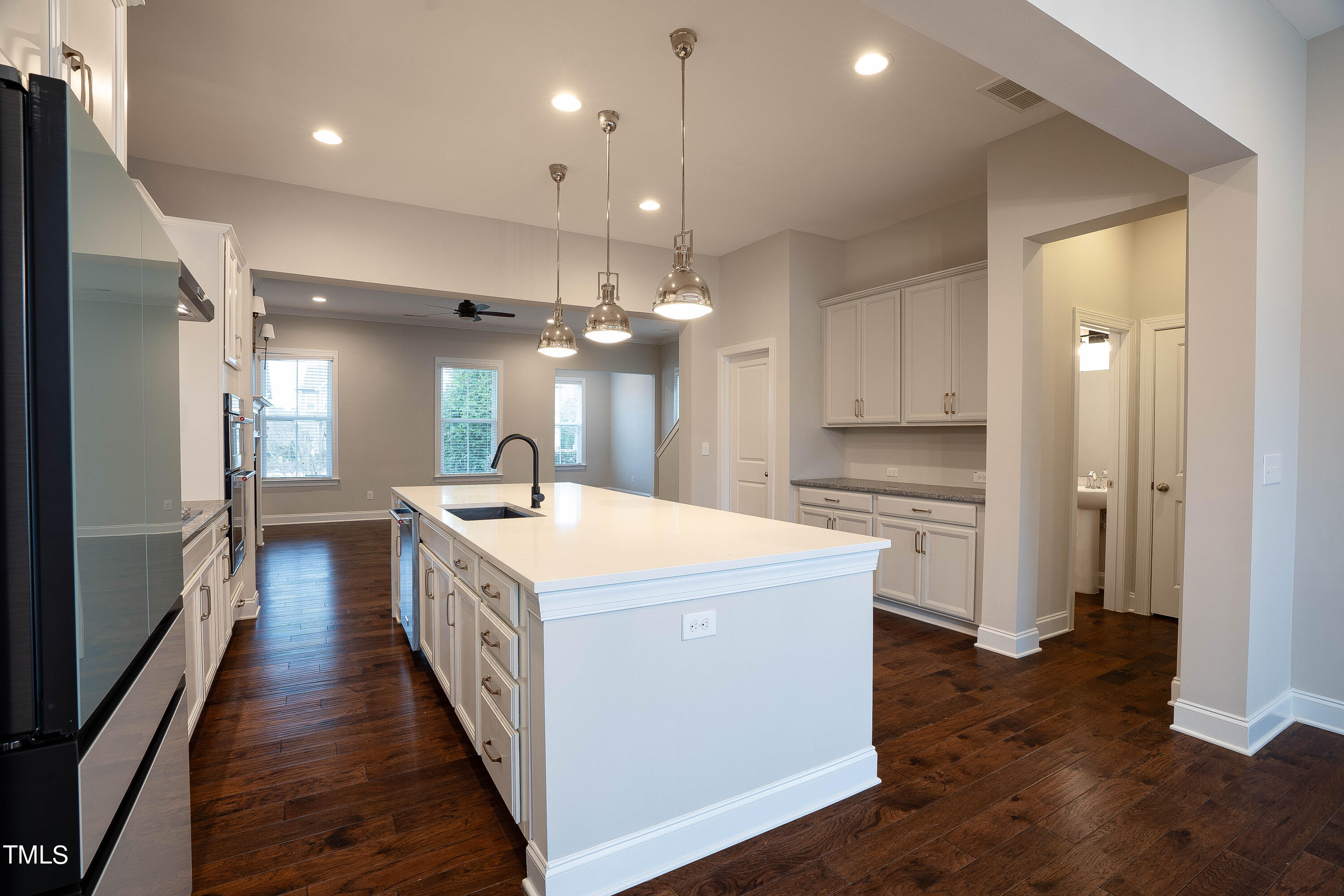 665 Old Dairy Drive Wake Forest, NC 27587 - Photo 7 of 30 a large kitchen with stainless steel appliances a large counter top a stove a refrigerator and a cabinets