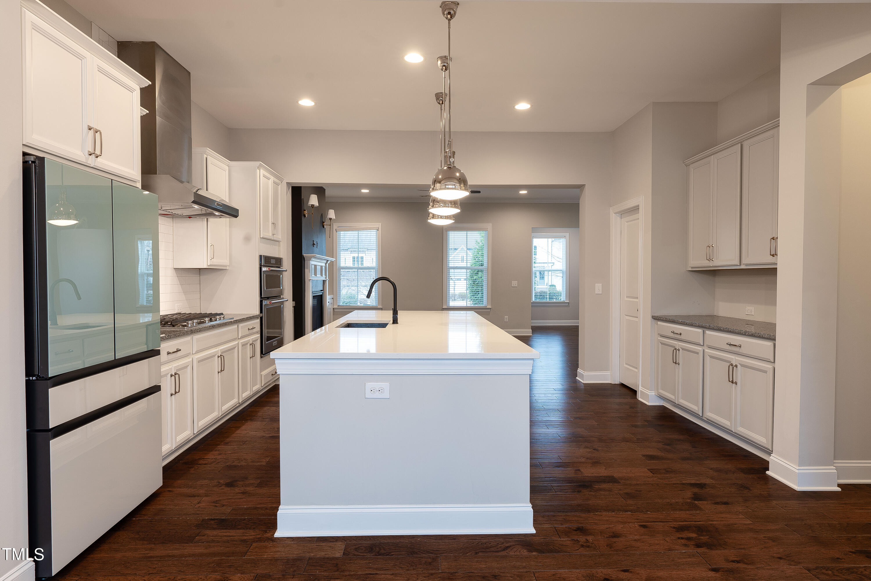 665 Old Dairy Drive Wake Forest, NC 27587 - Photo 8 of 30 a kitchen with stainless steel appliances kitchen island granite countertop a stove and a refrigerator