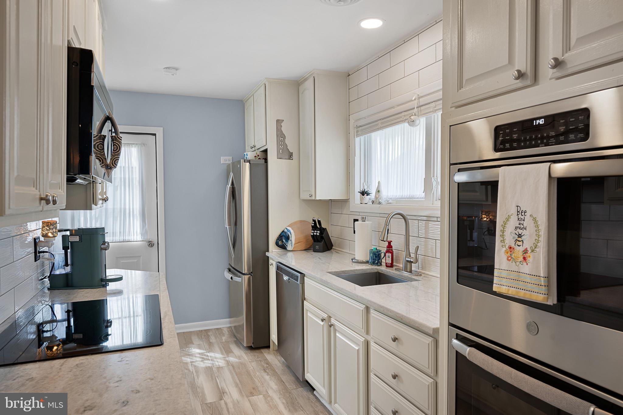 31186 Dogwood Acres Road Dagsboro, DE 19939 - Photo 11 of 43 a kitchen with stainless steel appliances a refrigerator sink and microwave