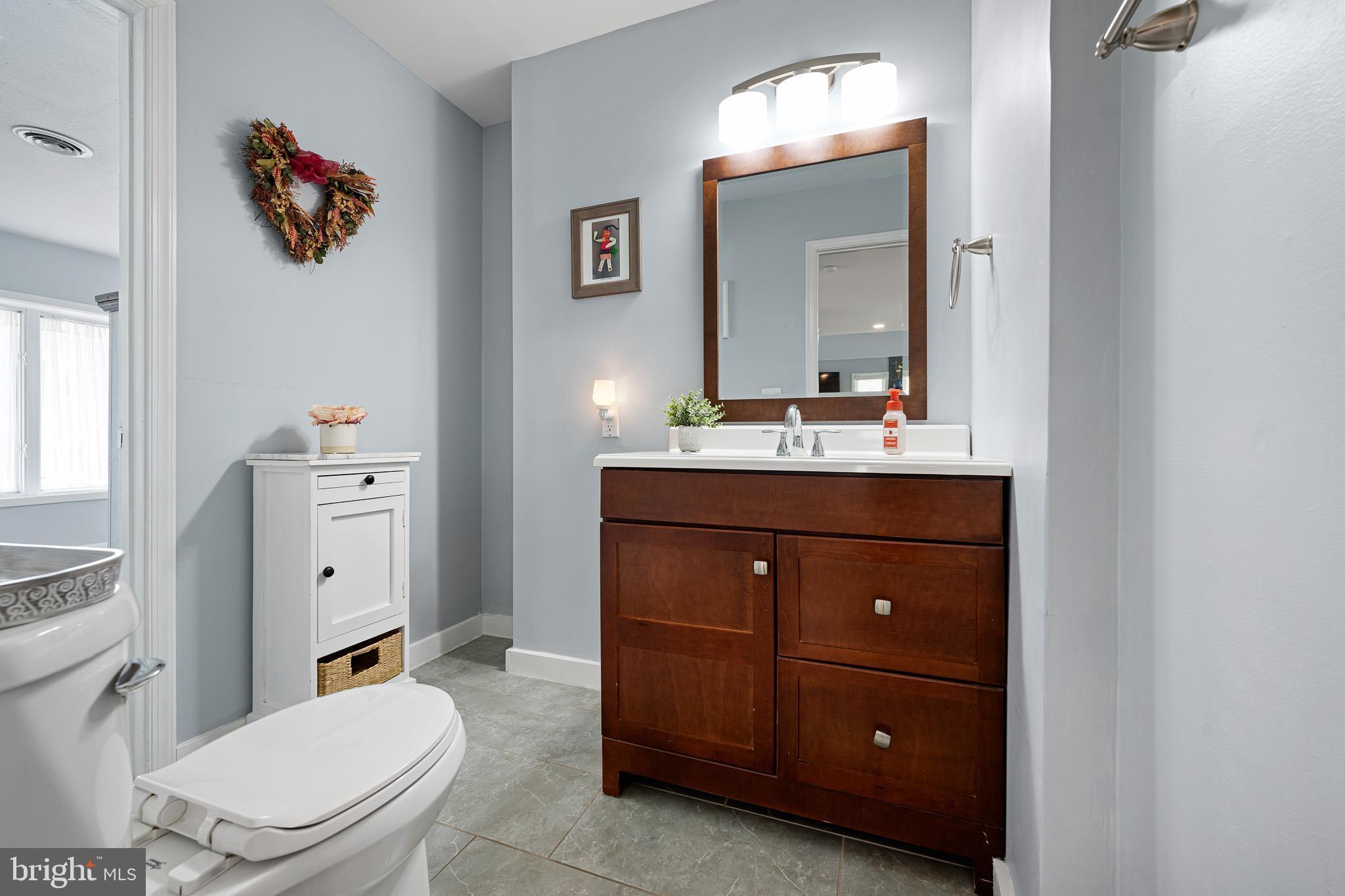 31186 Dogwood Acres Road Dagsboro, DE 19939 - Photo 17 of 43 a bathroom with a toilet a sink and a mirror