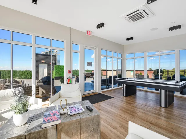 a living room with stainless steel appliances kitchen island granite countertop furniture and a wooden floor