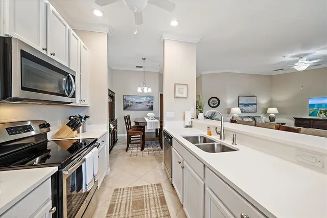 a kitchen with stainless steel appliances a sink stove top oven and cabinets