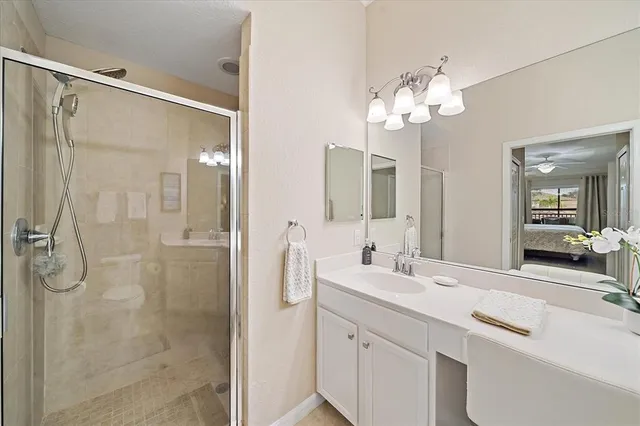 a bathroom with a double vanity sink mirror and shower