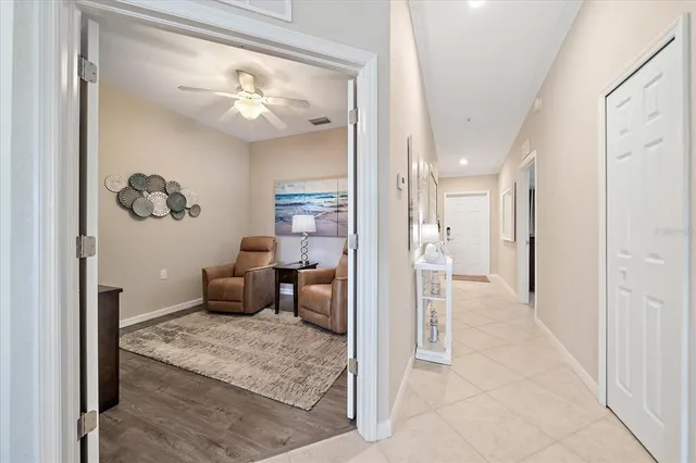 a view of a hallway with wooden floor windows and a livingroom