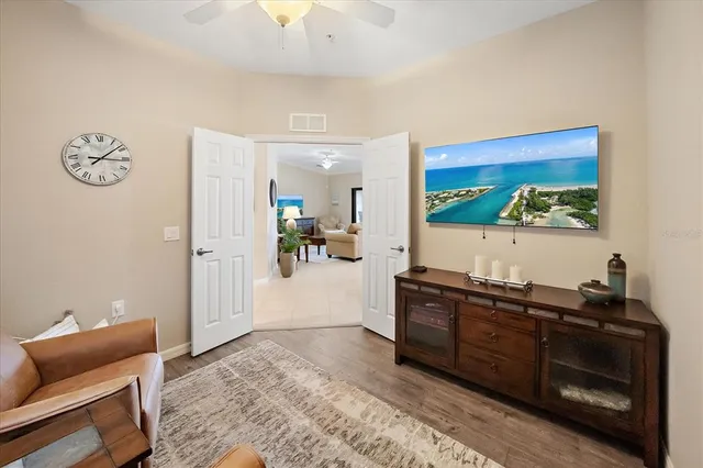 a living room with furniture and a wooden floor