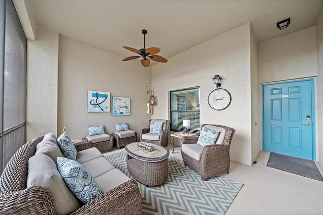 a living room with furniture a clock and a window