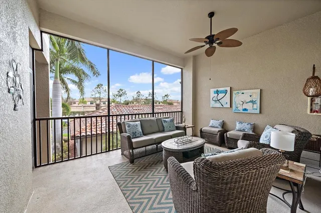 a living room with furniture and a floor to ceiling window