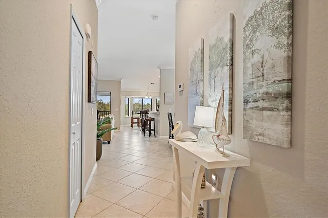 a living room with furniture a dining table and a chandelier