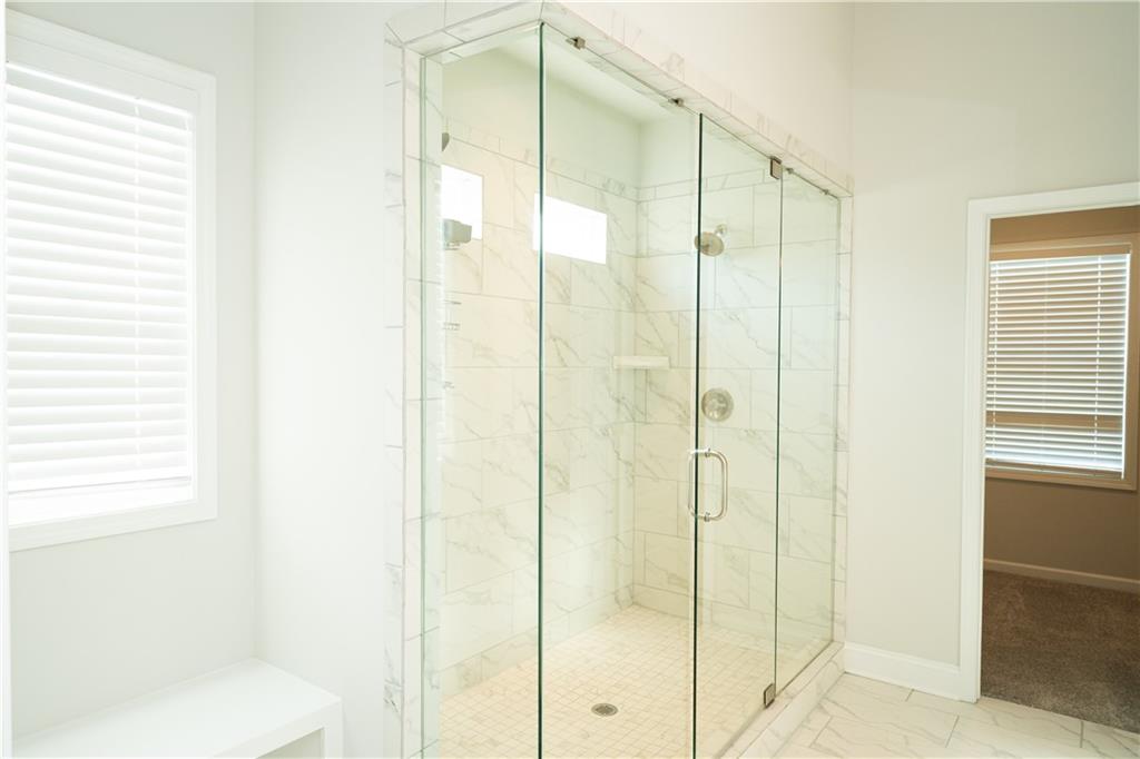 536 Sageton Court Grayson, GA 30017 - Photo 23 of 37 a bathroom with a shower and a toilet