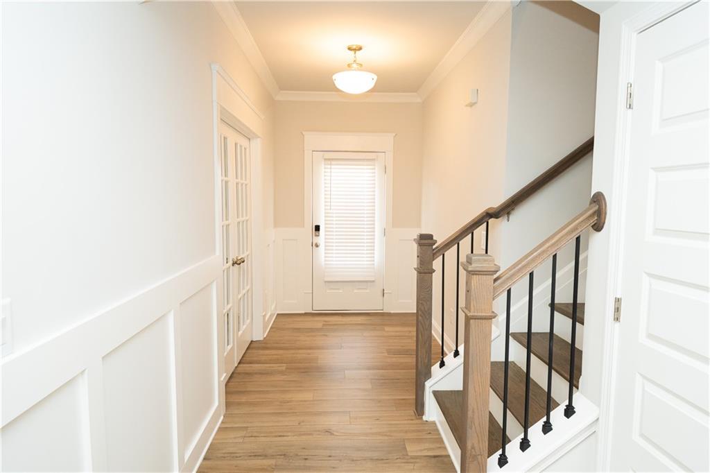 536 Sageton Court Grayson, GA 30017 - Photo 4 of 37 a view of a hallway with wooden floor and staircase
