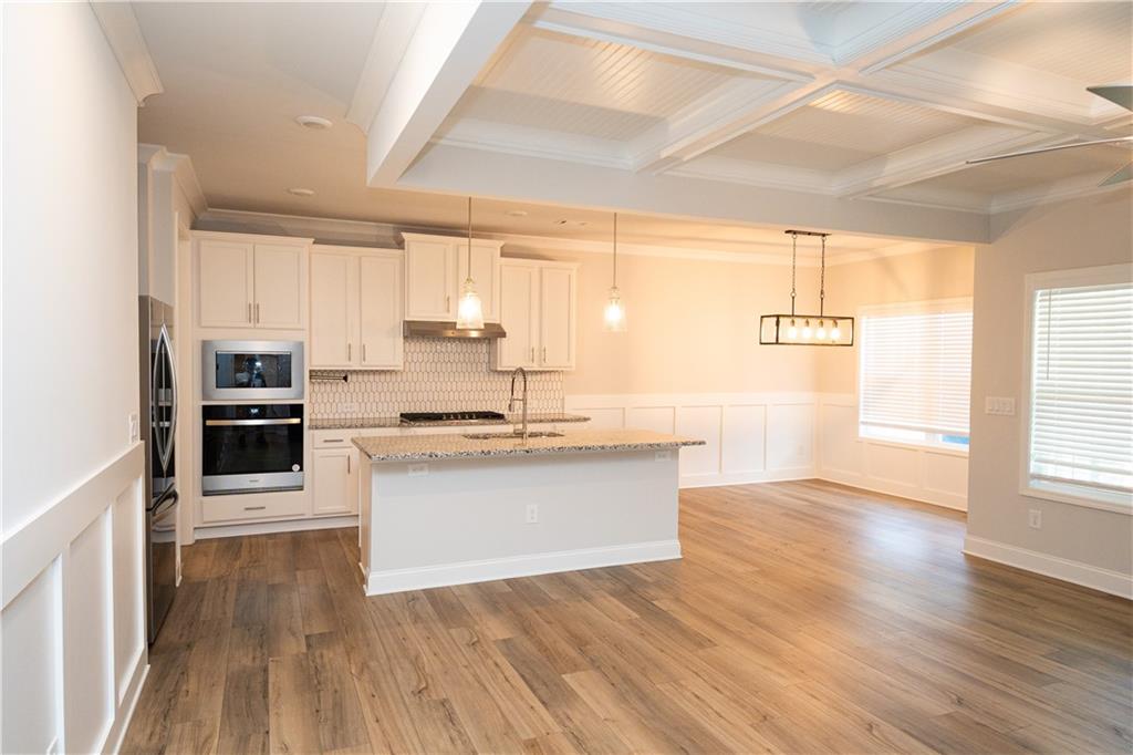 536 Sageton Court Grayson, GA 30017 - Photo 6 of 37 a kitchen with stainless steel appliances granite countertop a sink a stove cabinets counter space and a window