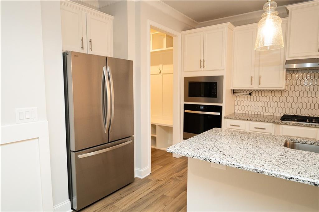 536 Sageton Court Grayson, GA 30017 - Photo 7 of 37 a kitchen with granite countertop a refrigerator and a sink