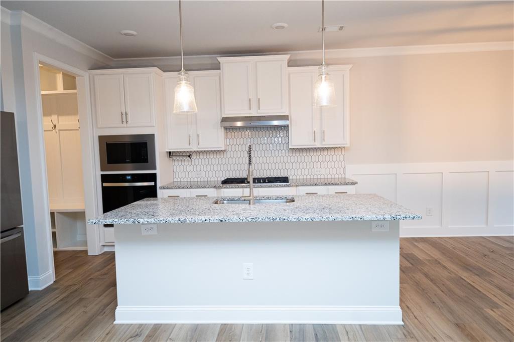 536 Sageton Court Grayson, GA 30017 - Photo 8 of 37 a large kitchen with granite countertop a stove a sink and a refrigerator
