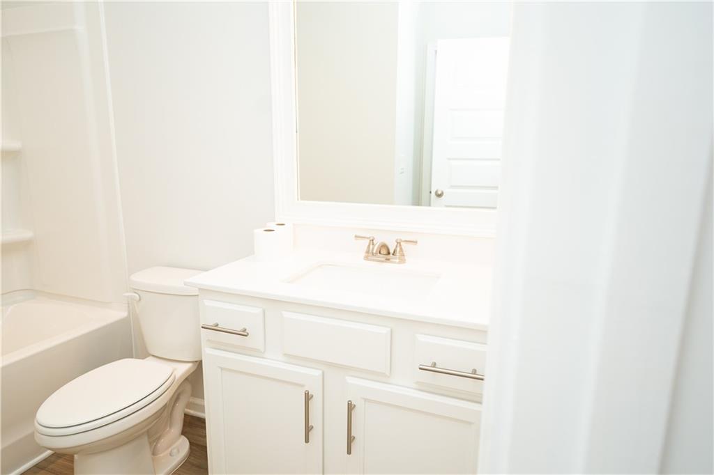 536 Sageton Court Grayson, GA 30017 - Photo 9 of 37 a bathroom with a sink a toilet and a mirror