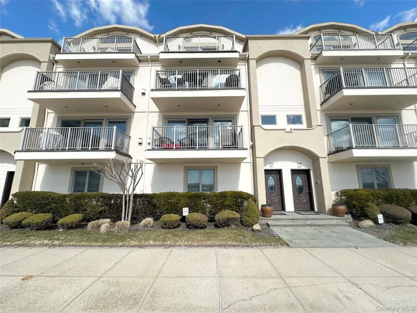 a front view of a residential apartment building with a yard