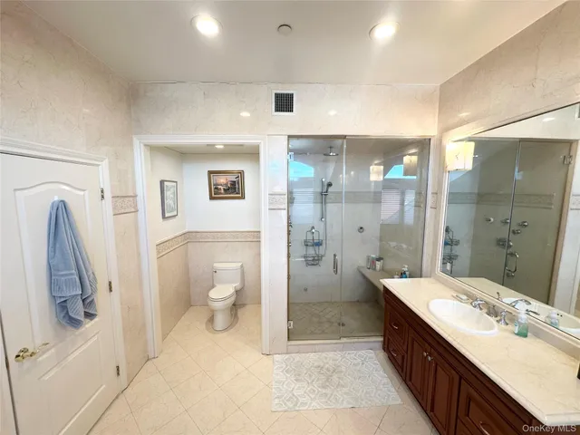 a spacious bathroom with a tub sink and mirror