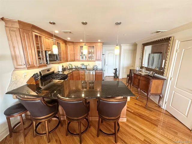 a kitchen with stainless steel appliances granite countertop sink stove and refrigerator