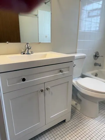 a bathroom with a sink a toilet and a mirror