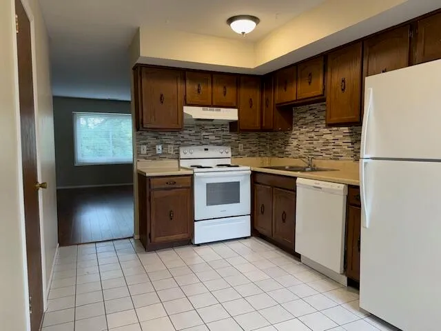 a kitchen with a stove sink and refrigerator