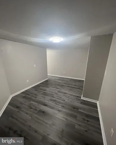 an empty room with wooden floor