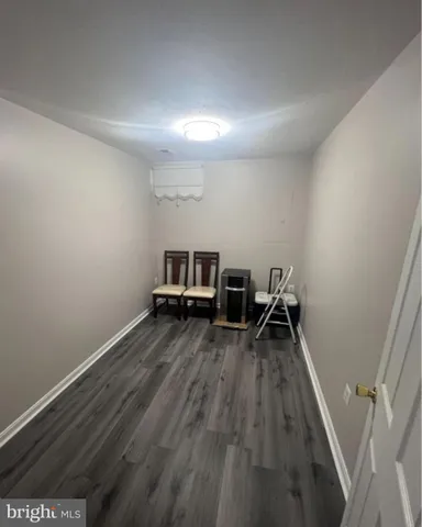 a view of a room with wooden floor and furniture