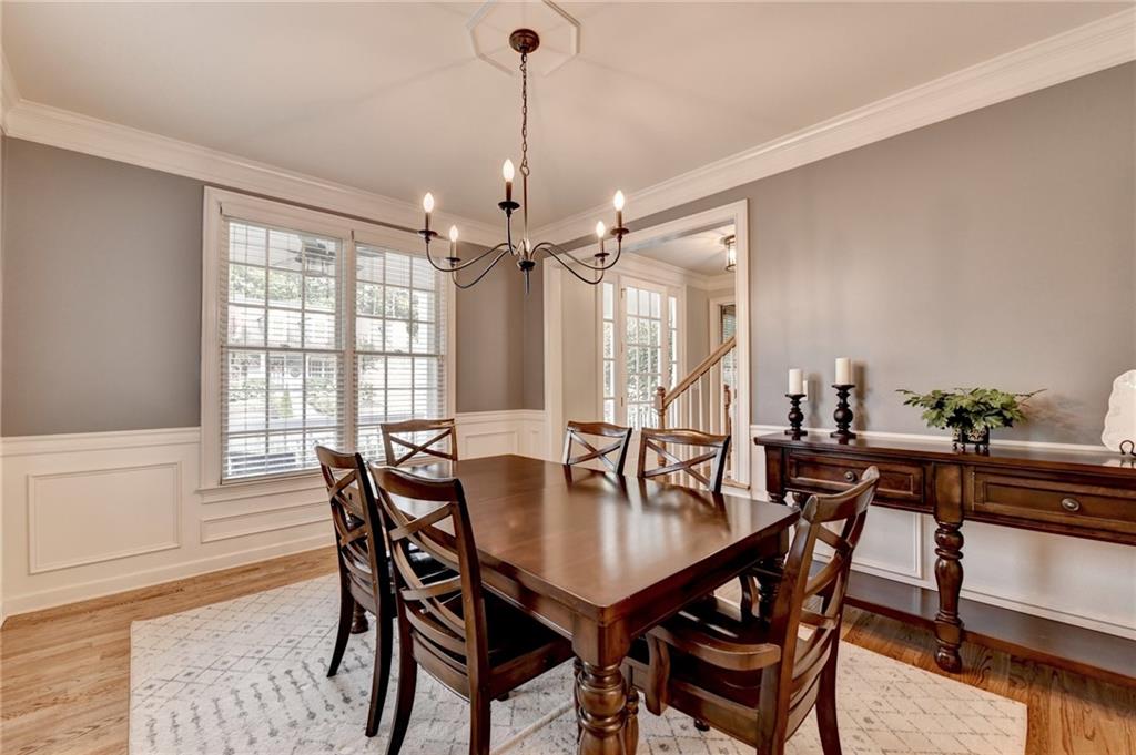 7051 Dove Point Lane Hoschton, GA 30548 - Photo 11 of 74 a view of a dining room and livingroom with furniture wooden floor and a chandelier