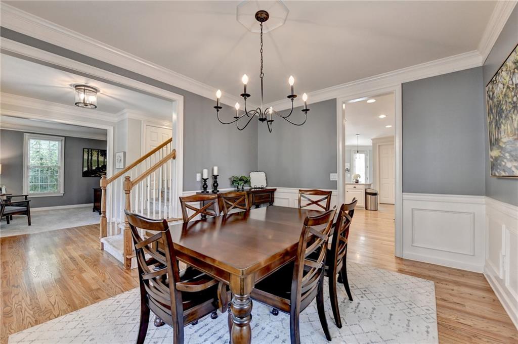 7051 Dove Point Lane Hoschton, GA 30548 - Photo 12 of 74 a view of a dining room with furniture and wooden floor