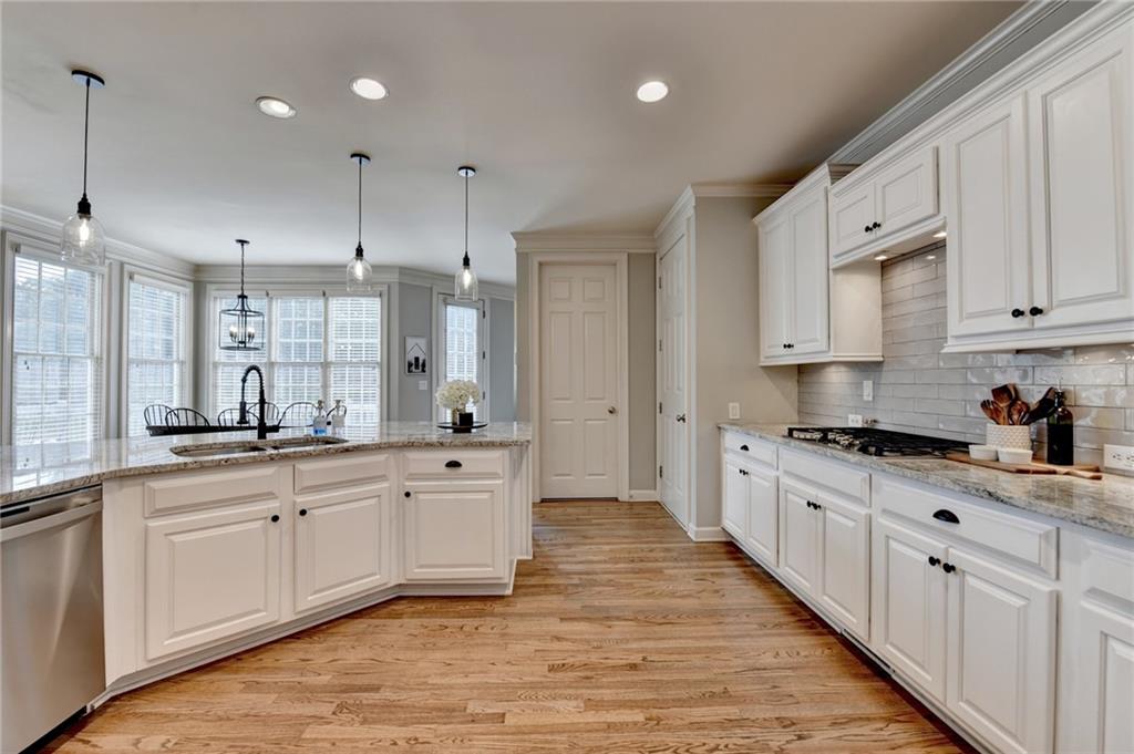7051 Dove Point Lane Hoschton, GA 30548 - Photo 14 of 74 a large kitchen with stainless steel appliances lots of counter space sink and cabinets